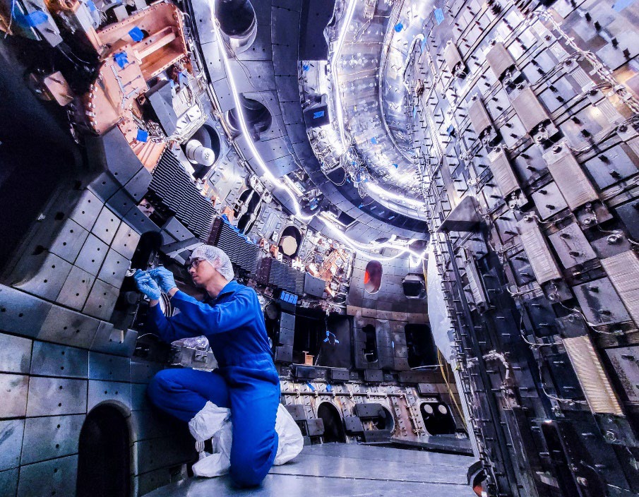 An engineer adjusts mirrors while installing new diagnostic equipment