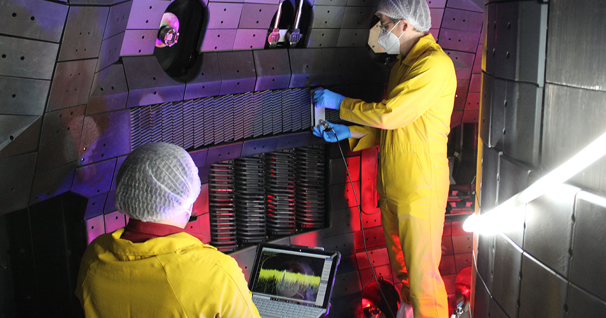 GA scientists complete installation of the “helicon” antenna (the grill-like structure at center) inside the DIII-D tokamak.