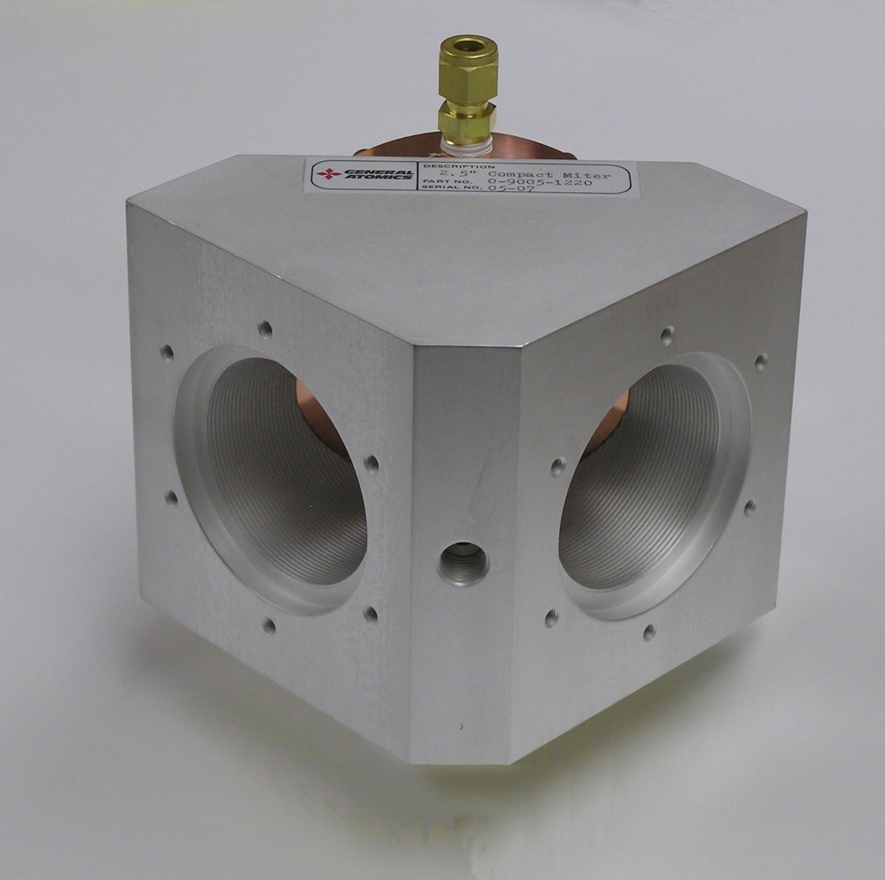 Non-vacuum miter bends are made with corrugated waveguides machined into a block